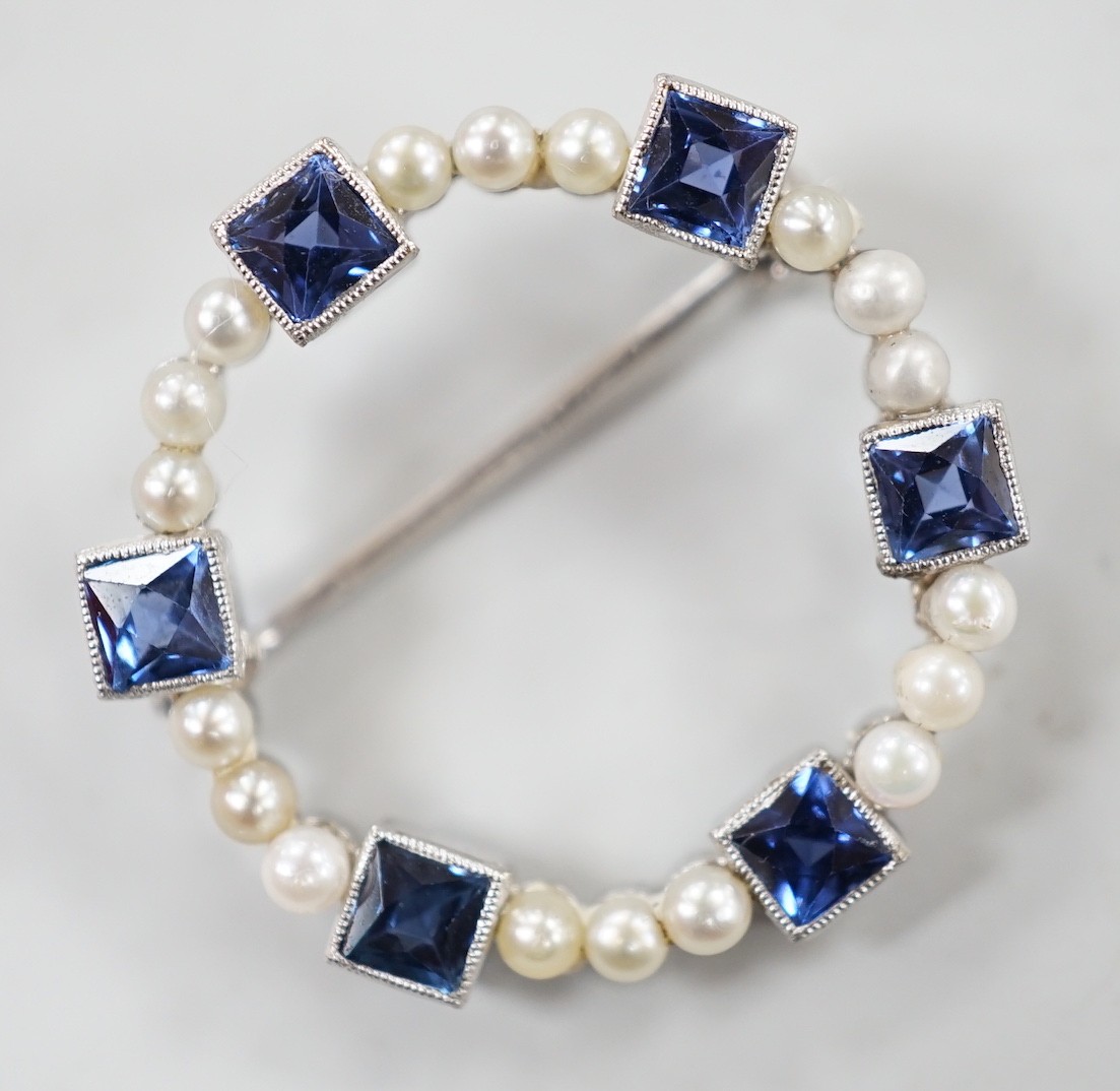 An 18k white metal, synthetic blue spinel? and seed pearl set openwork brooch, 24mm, gross weight 3 grams.